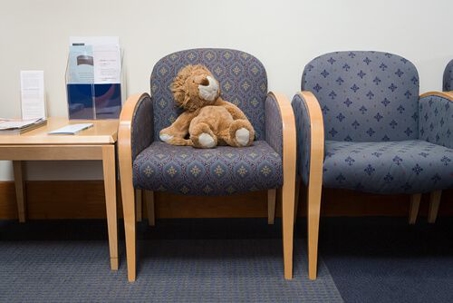Hospital waiting room with toy lion in a chair